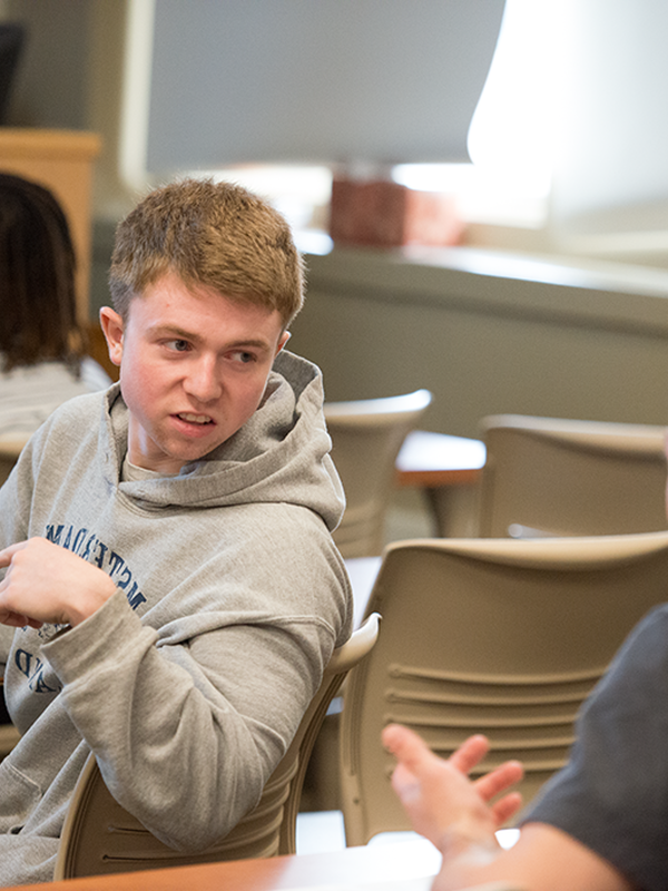 male student talking in classroom